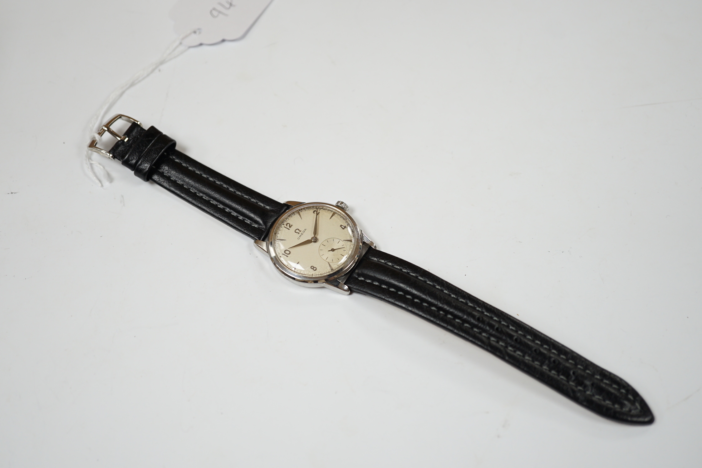 A gentleman's late 1950's stainless steel Omega manual wind wrist watch, with subsidiary seconds, on associated later leather strap, with Omega buckle, case diameter 35mm, no box or papers.